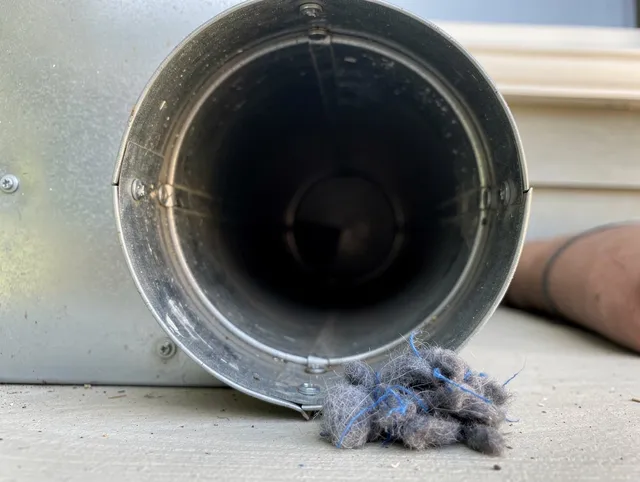 Simsbury Dryer Vent Cleaning technician using specialized equipment to clear severe dryer vent blockage in Simsbury